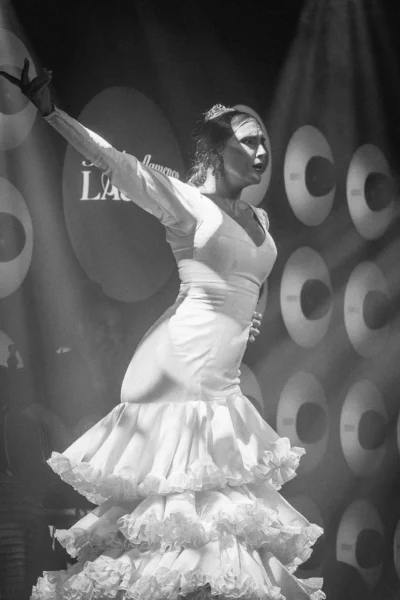 The History of Flamenco: From the Soul of Andalusia to the World Stage 1 Flamenco dancer in a white dress performing at Tablao Flamenco Las Setas in Seville